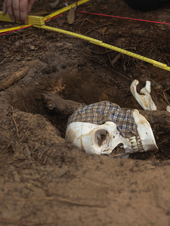 a fake skull and measuring tape at a mock crime scene