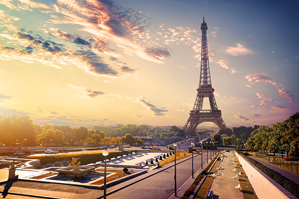 Eiffel Tower in France during a sunset with clouds in the background.