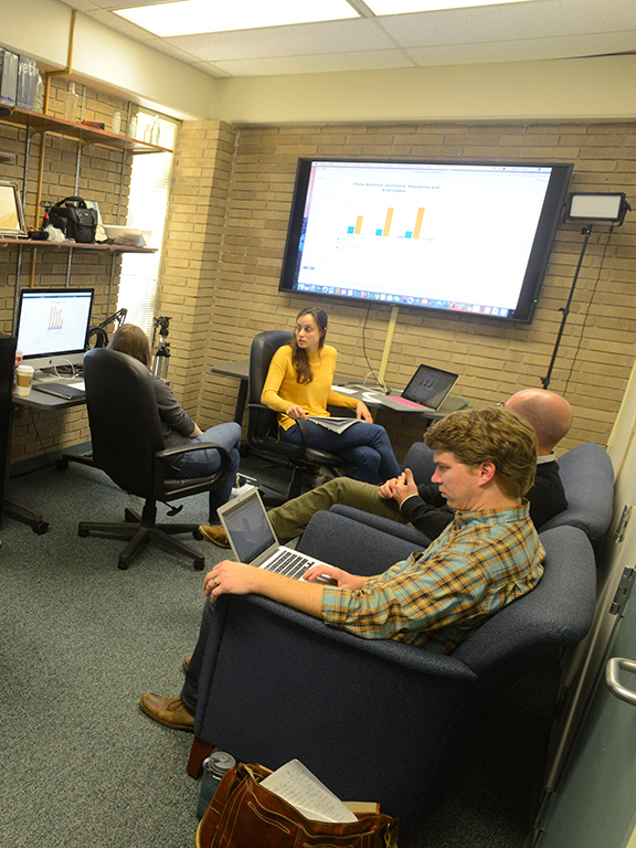 Six UWF history students using computers and laptops in the UWF Digital History Lab.