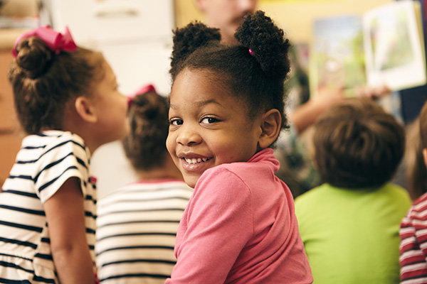 one elementary school student looking back at the camera