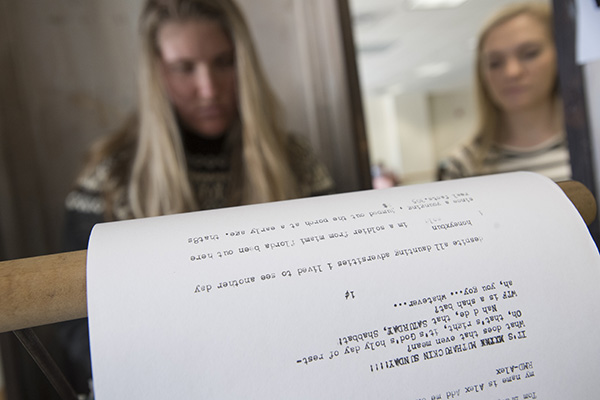 two students working on a typewriter