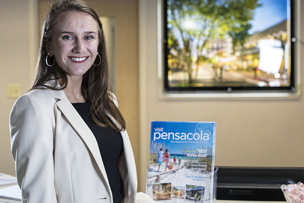 hospitality major giving directions to a client on a local paper map