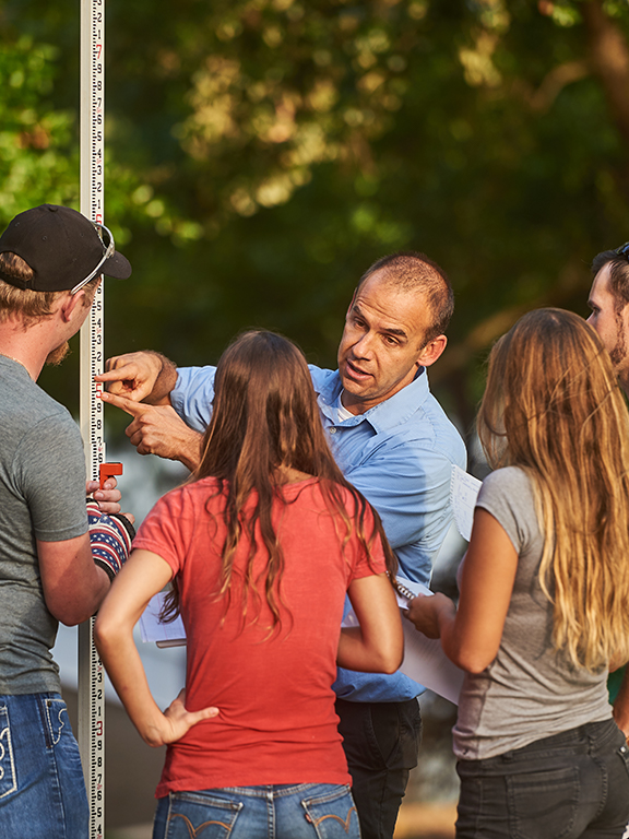 Class practices surveying techniques on the University of West Florida's main campus.	