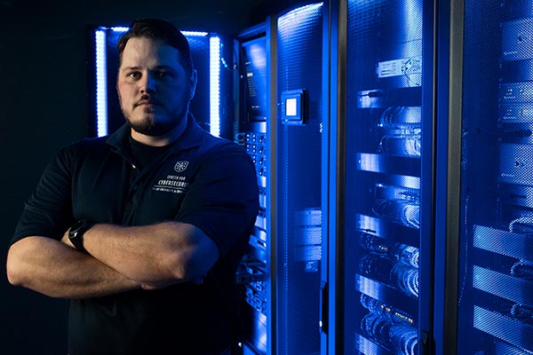 information security student in a server room