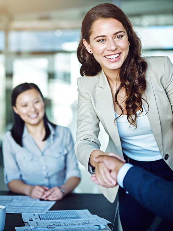 two people shaking hands at a business meeting