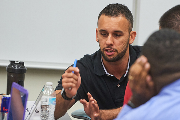 professor speaking with fellow classmates