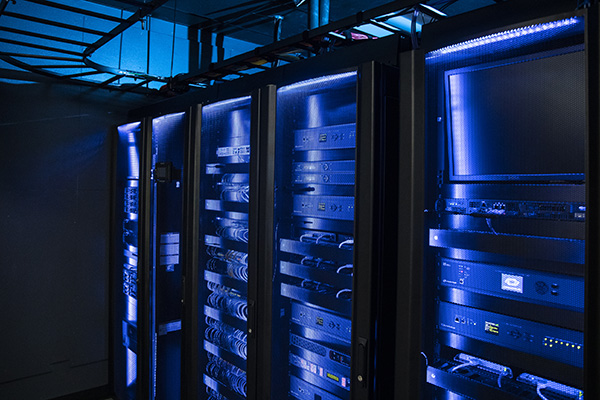 A row of four server cabinets in the UWF Center for Cybersecurity.