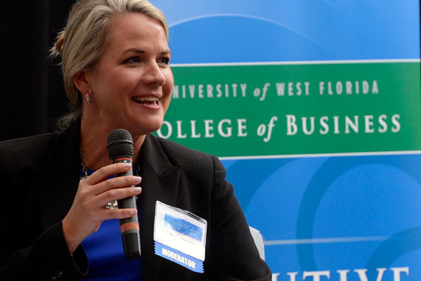 Management student speaking to a conference