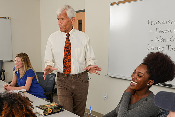 students listening to a professor in class