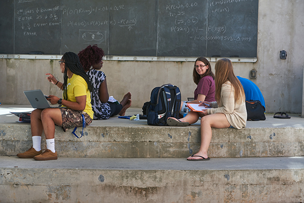 mathematical sciences students studying on a chalkboard outside of uwf building 4