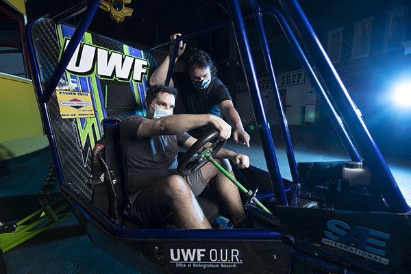 mechanical engineering students testing a solar powered go kart