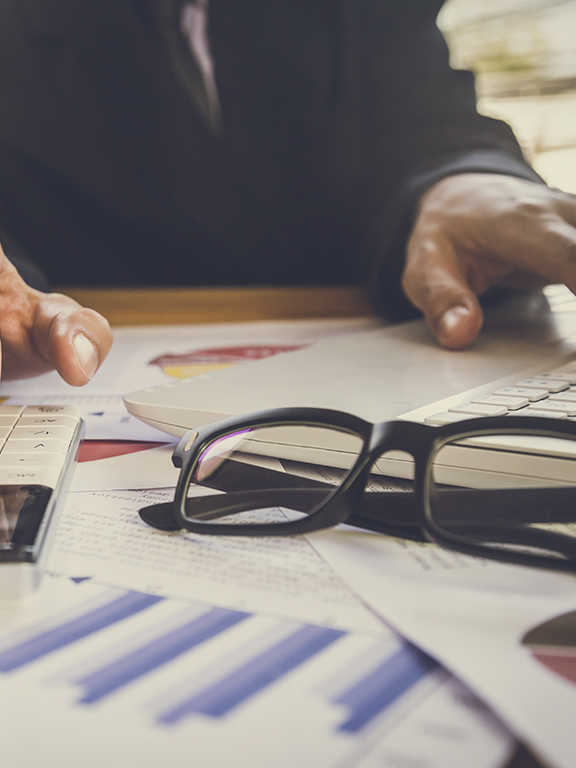 Accountant working on calculator to calculate accounting and business finance plan
