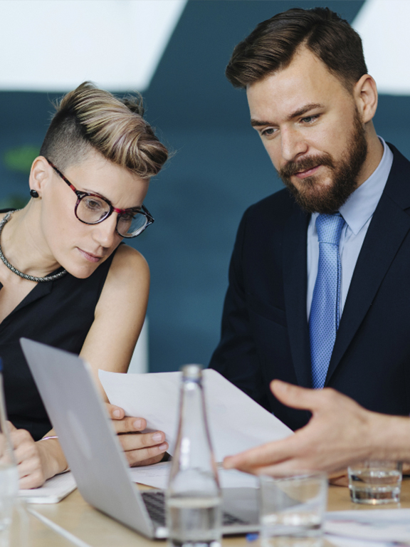 Business professionals looking at a contract at a meeting table