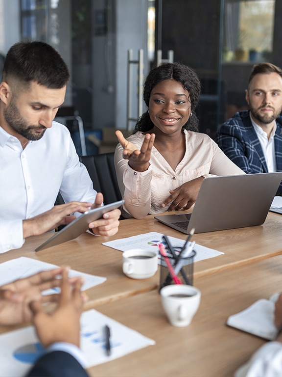 Business professionals brainstorming at a table during a corporate meeting.