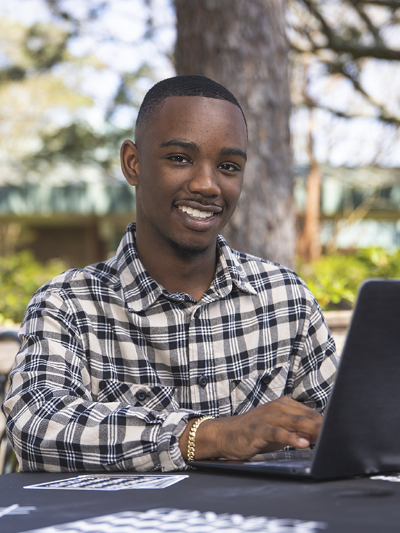 Management student smiling at camera