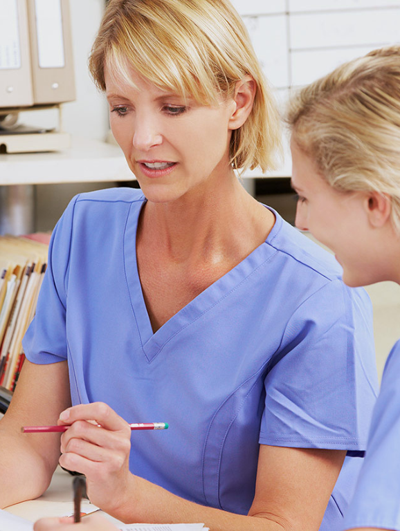Female nurse teaching a female nursing student