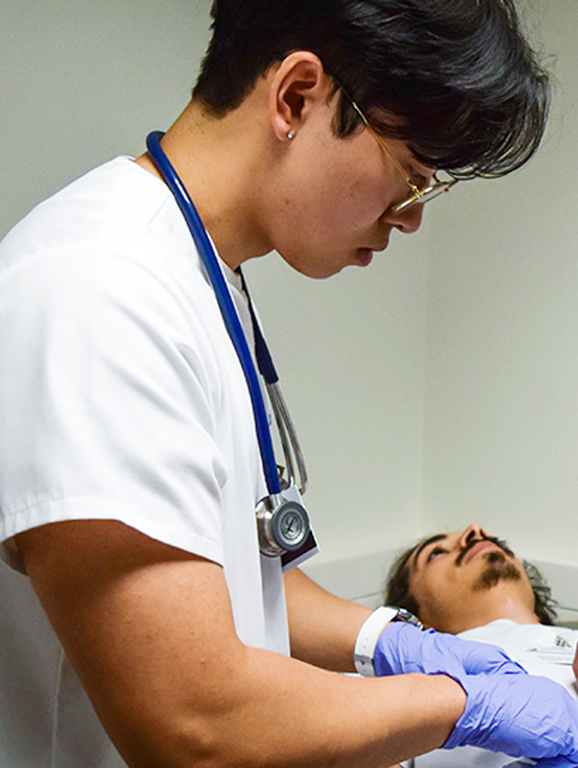 MSN nursing professor with student and patient
