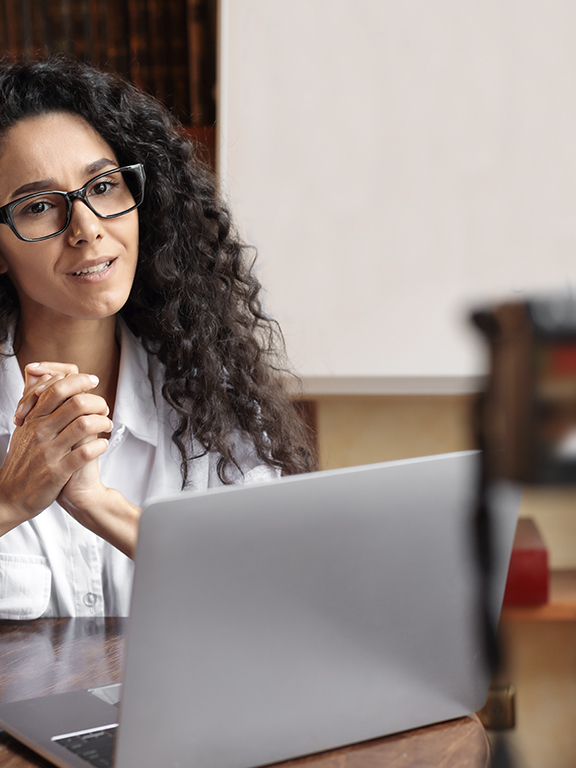 Teacher recording an online lesson with a camera and laptop.