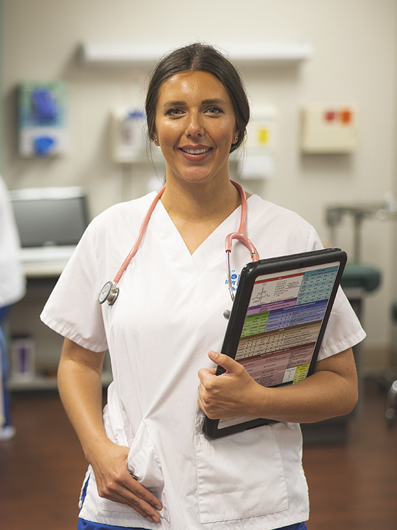 UWF nursing students in exam room with simulation patient