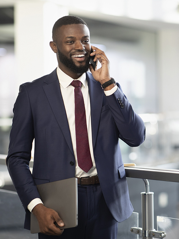 Sports manager in professional attire talking on a mobile phone.