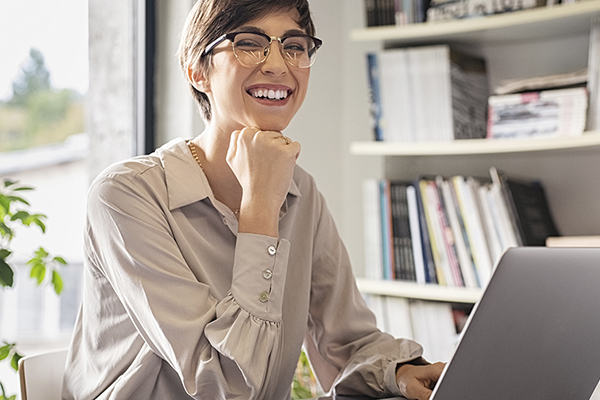 Business entrepreneur using a laptop in a home office setting.