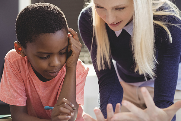 Behavior Analyst working with a child during therapy session.