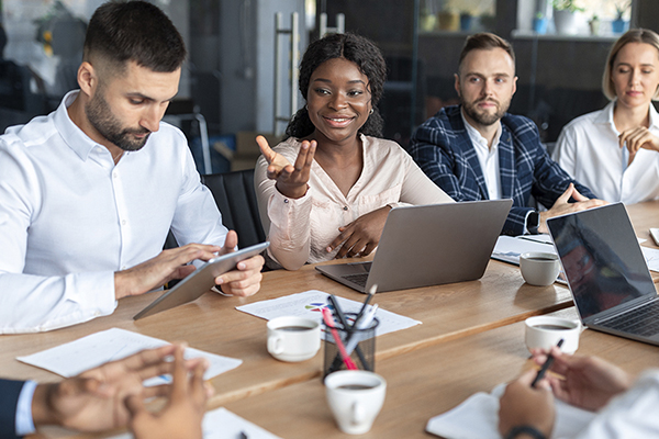 Business professionals brainstorming at a table during a corporate meeting.