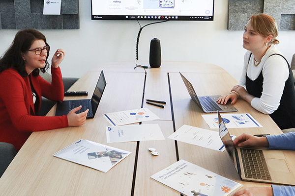 Instructional design team reviewing content in conference room.