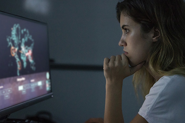 Cybersecurity student analysing data on a computer screen.