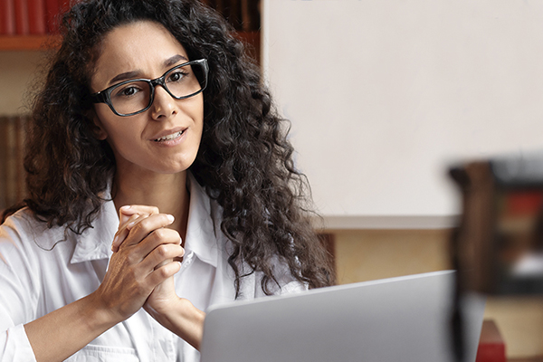 Teacher recording an online lesson with a camera and laptop.