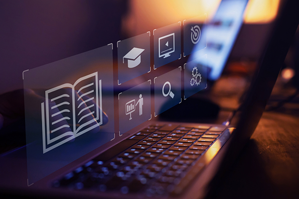 Seven square-shaped virtual icons related to Instructional Technology displayed above a laptop keyboard.