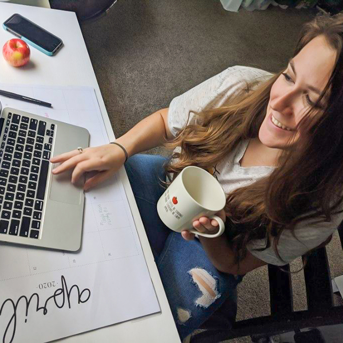 UWF student working on their laptop to teach remotely