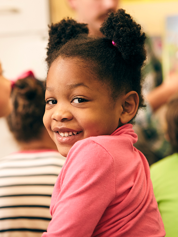 Elementary student looking back and smiling	