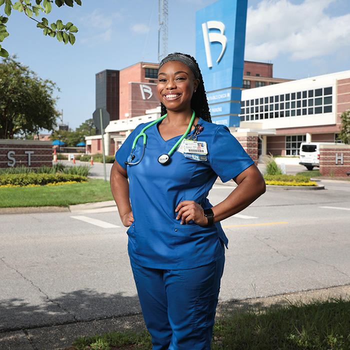 UWF alumna Praise Pettus poses in front of Baptist Hospital