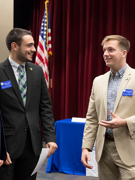 four student government association members conversing after a meeting	