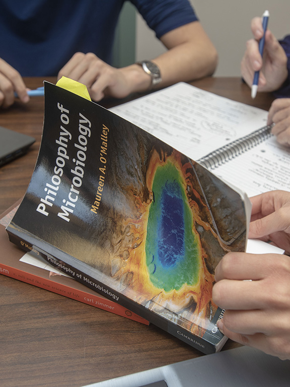 students and faculty discussing a passage from a philosophy textbook