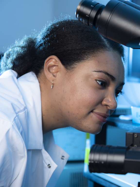 a student working with a microscope