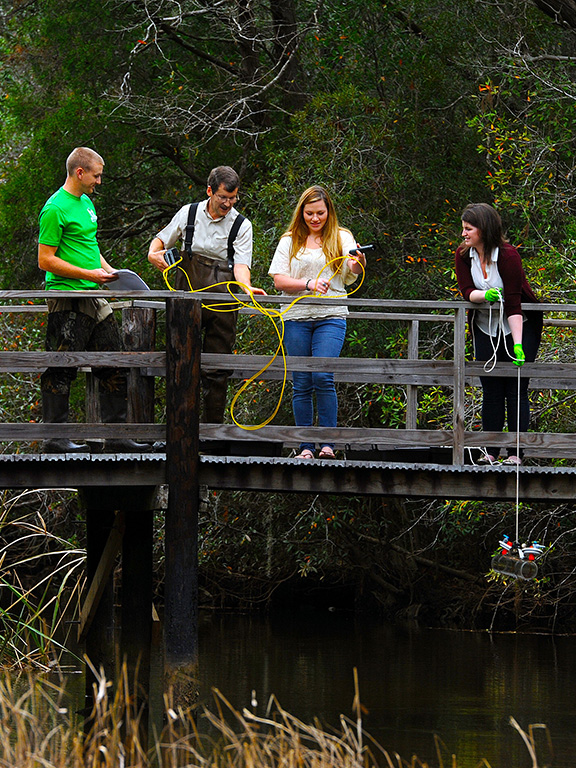 dr johan liebens and students taking water samples