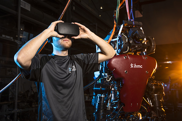 robotics student testing a robot using a virtual reality headset at the ihmc