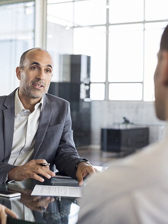 Financial agent showing new investment to young couple