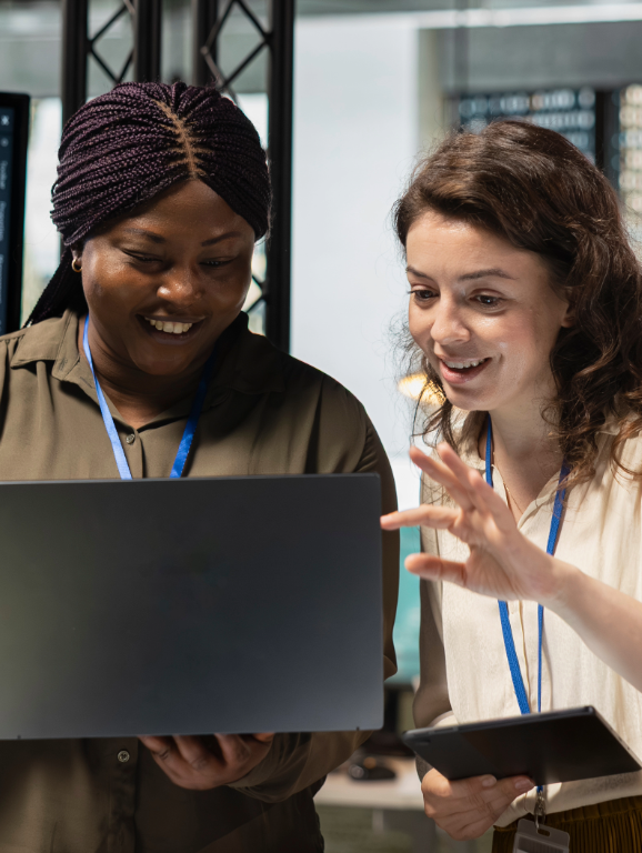 Two women collaborating on AI