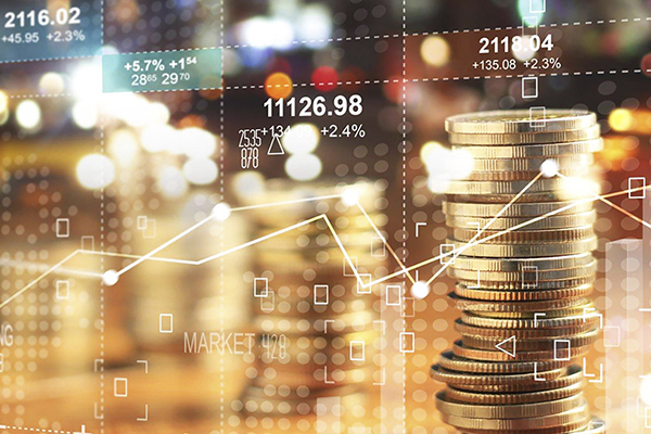 Stack of gold coins and a display of various finance charts and graphs.