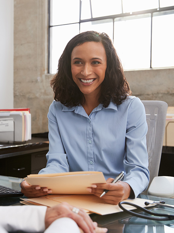 Human resources professional meeting with an employee in an office.