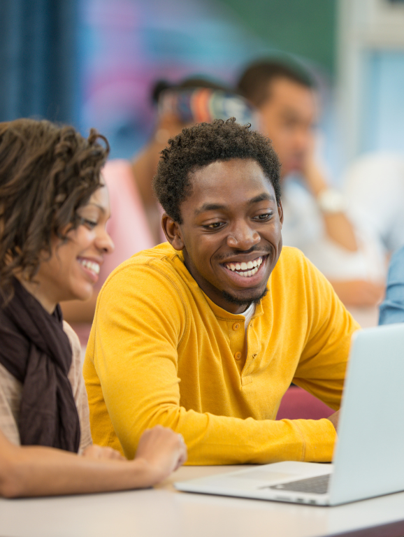 Two students collaborating on a computer