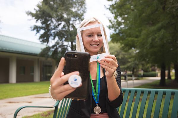 Social media professional staging a selfie photo for a social media post.