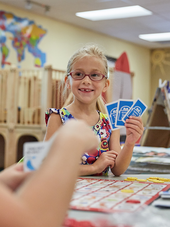 Teacher playing cards with a child	