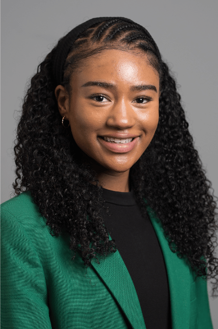 Headshot of a Student ambassador with a green jacket on