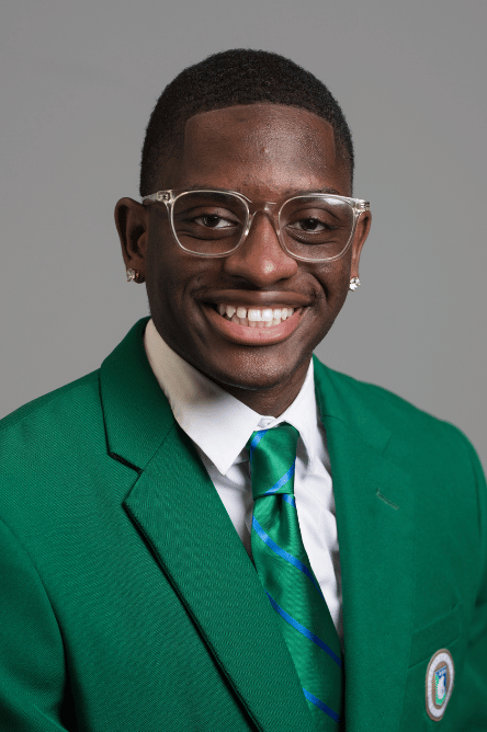 Headshot of a Student ambassador with a green jacket on