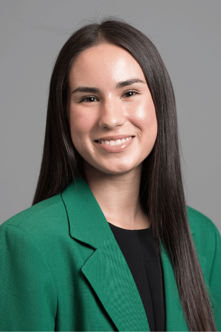 Headshot of a Student ambassador with a green jacket on