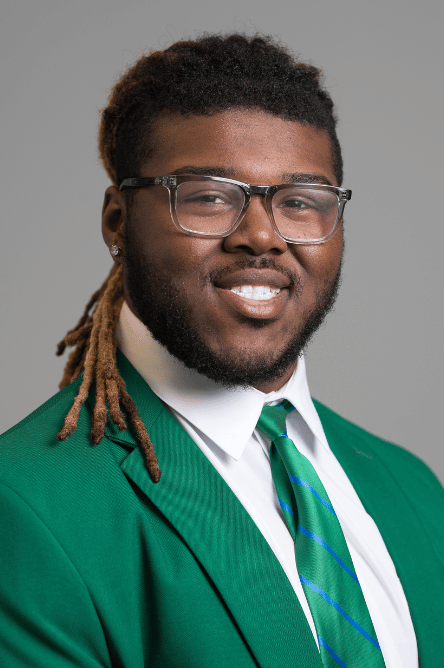 Headshot of a Student ambassador with a green jacket on